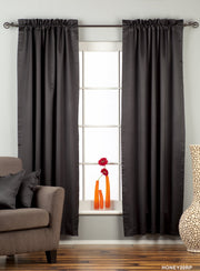 Black sari rod pocket curtains hung at a window