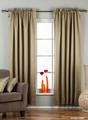 Olive green sari rod pocket curtains hung at a window