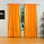 Pumpkin sari rod pocket curtains hung at a window