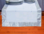 Silver silk table runner running down a dining table