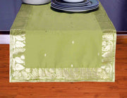 Olive green silk table runner running down a dining table