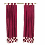 Maroon sari tab top curtains hung at a window