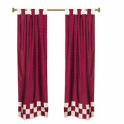 Maroon sari tab top curtains hung at a window