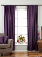 Purple velvet rod pocket curtains hung at a window