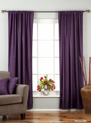 Purple velvet rod pocket curtains hung at a window