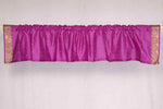 Violet sari valance mounted above a window
