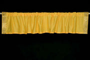 Yellow sari valance mounted above a window