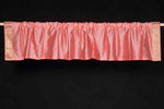 Peach sari valance mounted above a window