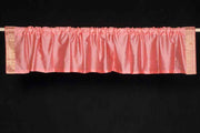 Peach sari valance mounted above a window