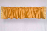 Pumpkin sari valance mounted above a window