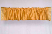Pumpkin sari valance mounted above a window