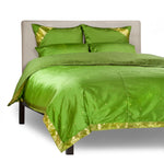 Forest green sari duvet cover set made up on a bed