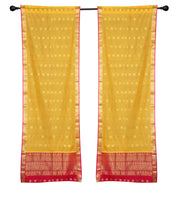 Yellow sari rod pocket curtains hung at a window