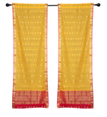 Yellow sari rod pocket curtains hung at a window