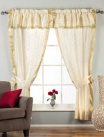 Cream sari rod pocket curtains hung at a window