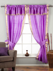 Cream sari rod pocket curtains hung at a window