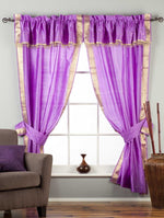 Cream sari rod pocket curtains hung at a window