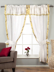 Cream sari rod pocket curtains hung at a window