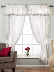 Cream sari rod pocket curtains hung at a window