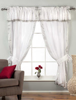 Cream sari rod pocket curtains hung at a window