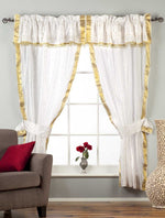 Cream sari rod pocket curtains hung at a window