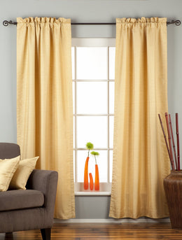 Golden rod raw silk rod pocket curtains hung at a window