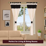 Cream raw silk tab top curtains hung at a window