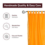 Pumpkin sari tab top curtains hung at a window