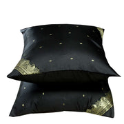 Black sari cushion covers arranged on a sofa
