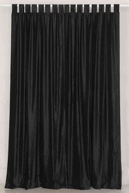 Black velvet tab top curtains hung at a window