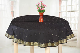 Black sari tablecloth laid on a dining table
