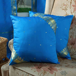 Cool blue sari cushion covers arranged on a sofa