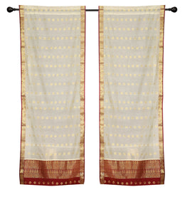 Cream sari rod pocket curtains hung at a window