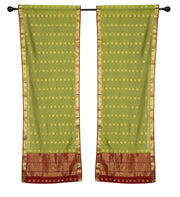 Green sari rod pocket curtains hung at a window