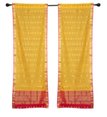 Yellow sari rod pocket curtains hung at a window