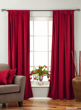 Burgundy velvet tab top curtains hung at a window
