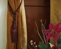 Brown sari curtain tiebacks holding a panel open