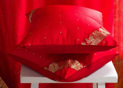 Fire brick sari cushion covers arranged on a sofa