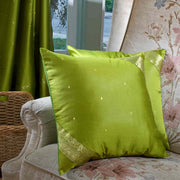 Olive green sari cushion covers arranged on a sofa