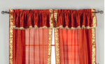 Cream sari rod pocket curtains hung at a window