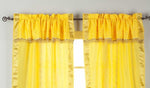 Cream sari rod pocket curtains hung at a window