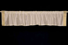 Cream sari valance mounted above a window