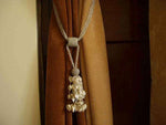 Cream sari curtain tiebacks holding a panel open