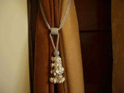 Cream sari curtain tiebacks holding a panel open