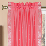 Silver sari rod pocket curtains hung at a window