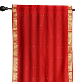 Red sari rod pocket curtains hung at a window