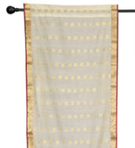 Cream sari rod pocket curtains hung at a window