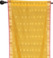 Yellow sari rod pocket curtains hung at a window