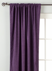 Purple velvet rod pocket curtains hung at a window