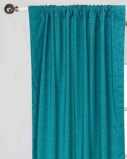 Turquoise velvet rod pocket curtains hung at a window